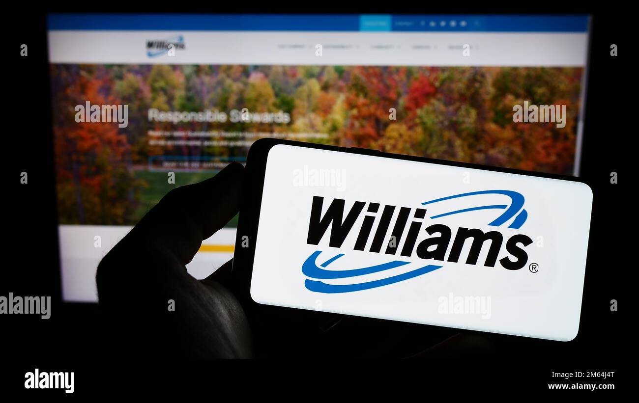 Person holding smartphone with logo of US energy company Williams Companies Inc. on screen in front of website. Focus on phone display. Stock Photo