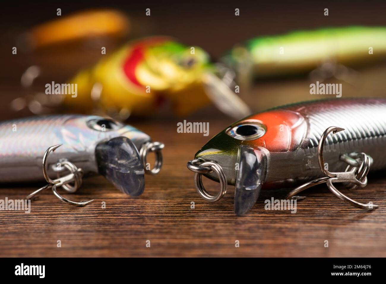 https://c8.alamy.com/comp/2M64J76/colorful-fishing-lures-wobbler-spinner-on-wood-desk-different-fishing-baits-2M64J76.jpg