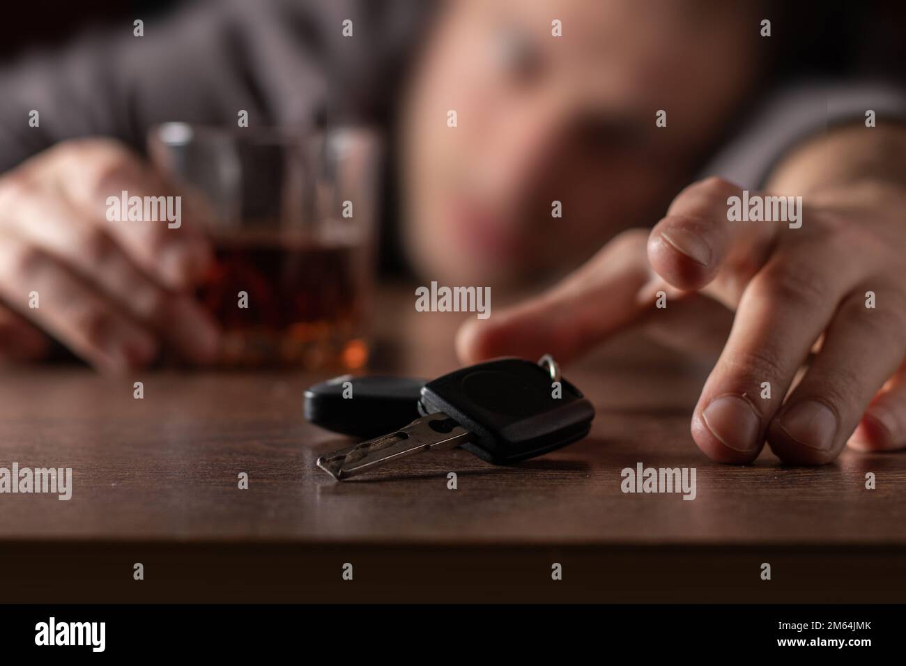 Do not drink and drive. Drunk man with glass alcohol in hand taking car ...