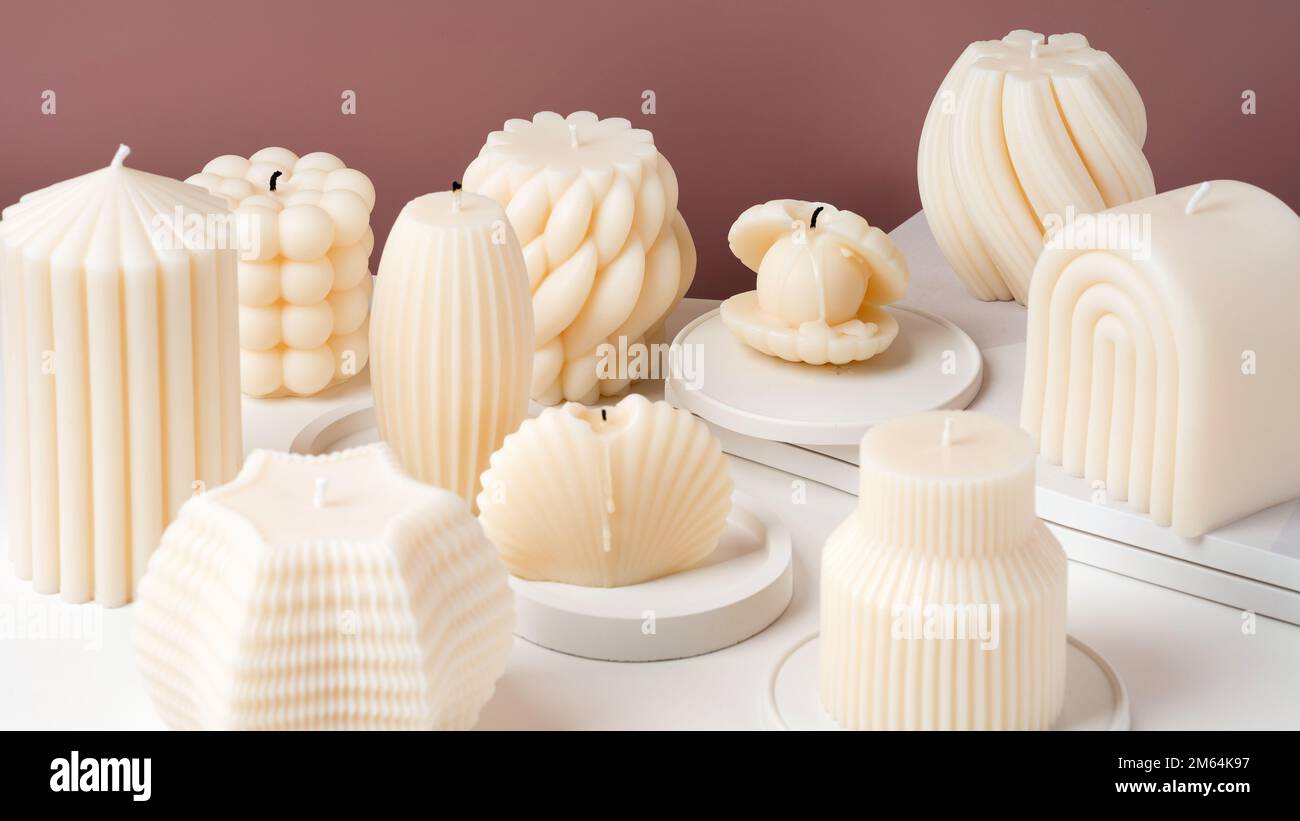 The Group of Handmade olive wax candle on a pink and white background