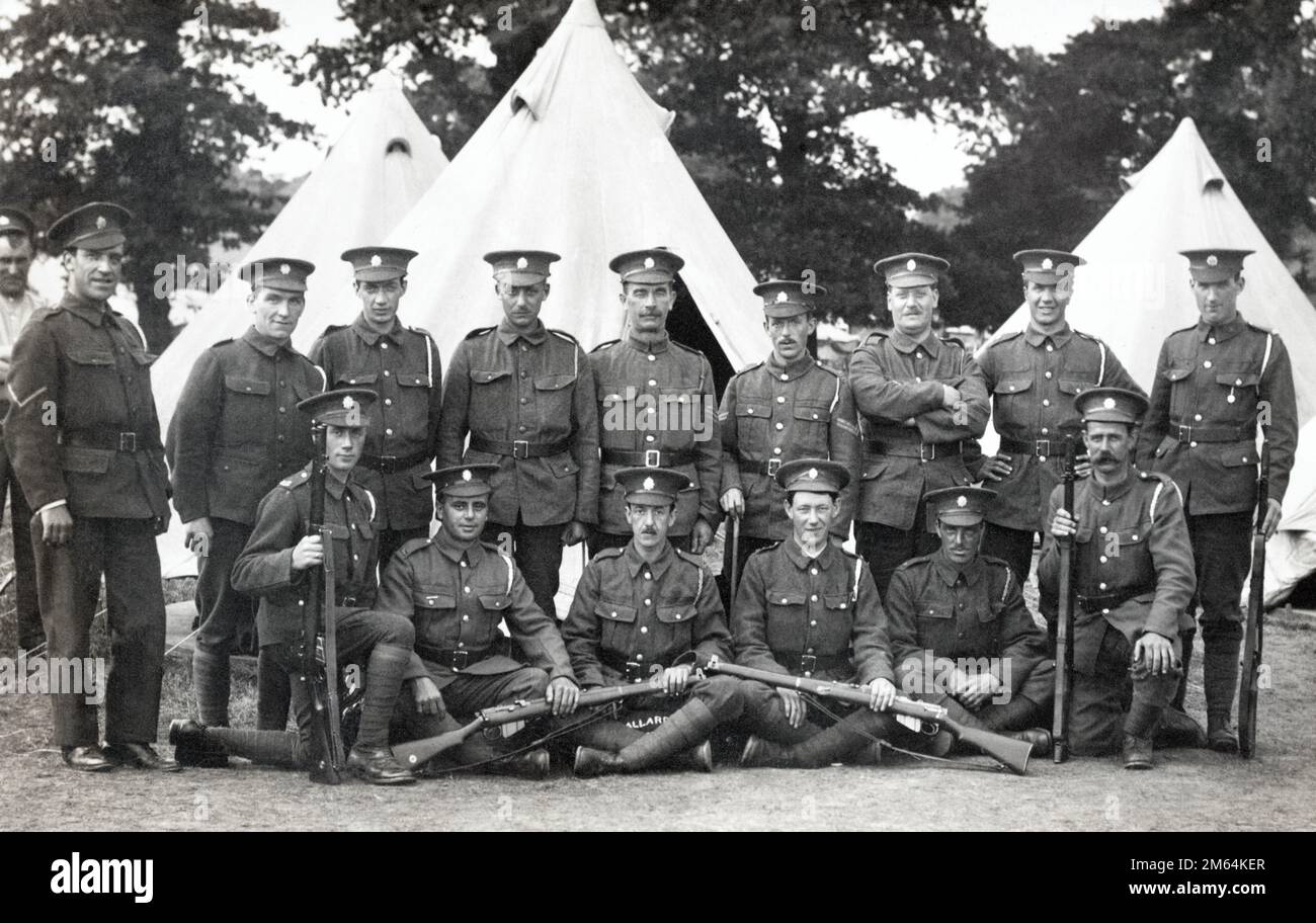 A group of soldiers in the Army Service Corps posing with their rifles in camp during the First World War. Stock Photo
