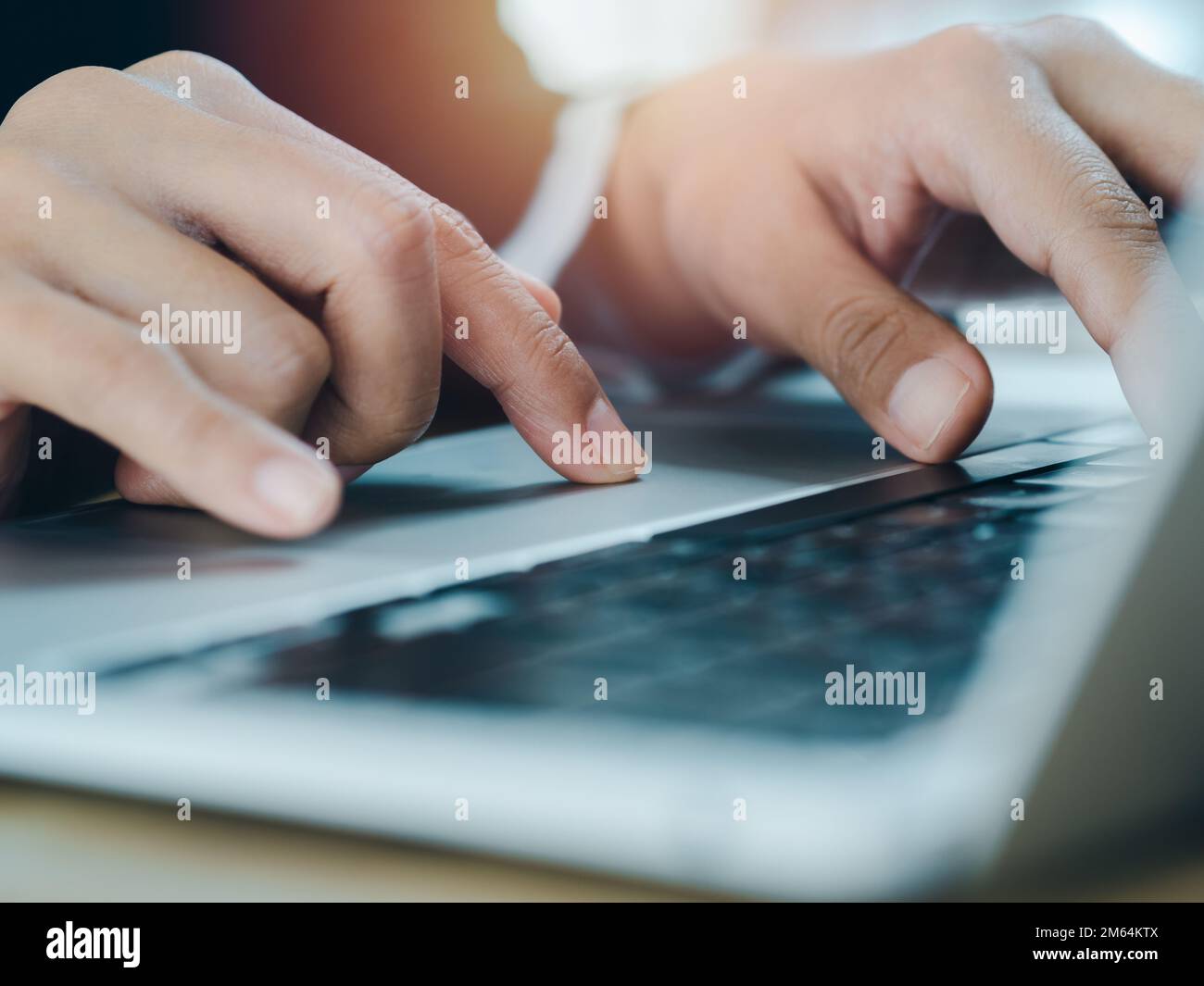 Close-up finger of business person in suit touch on touchpad while typing on keyboard on laptop computer. Working on notebook, business technology con Stock Photo