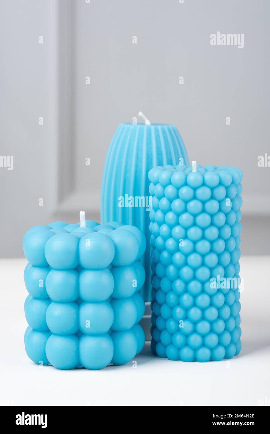 Handmade olive wax different forms blue color candle on a on the white table at home