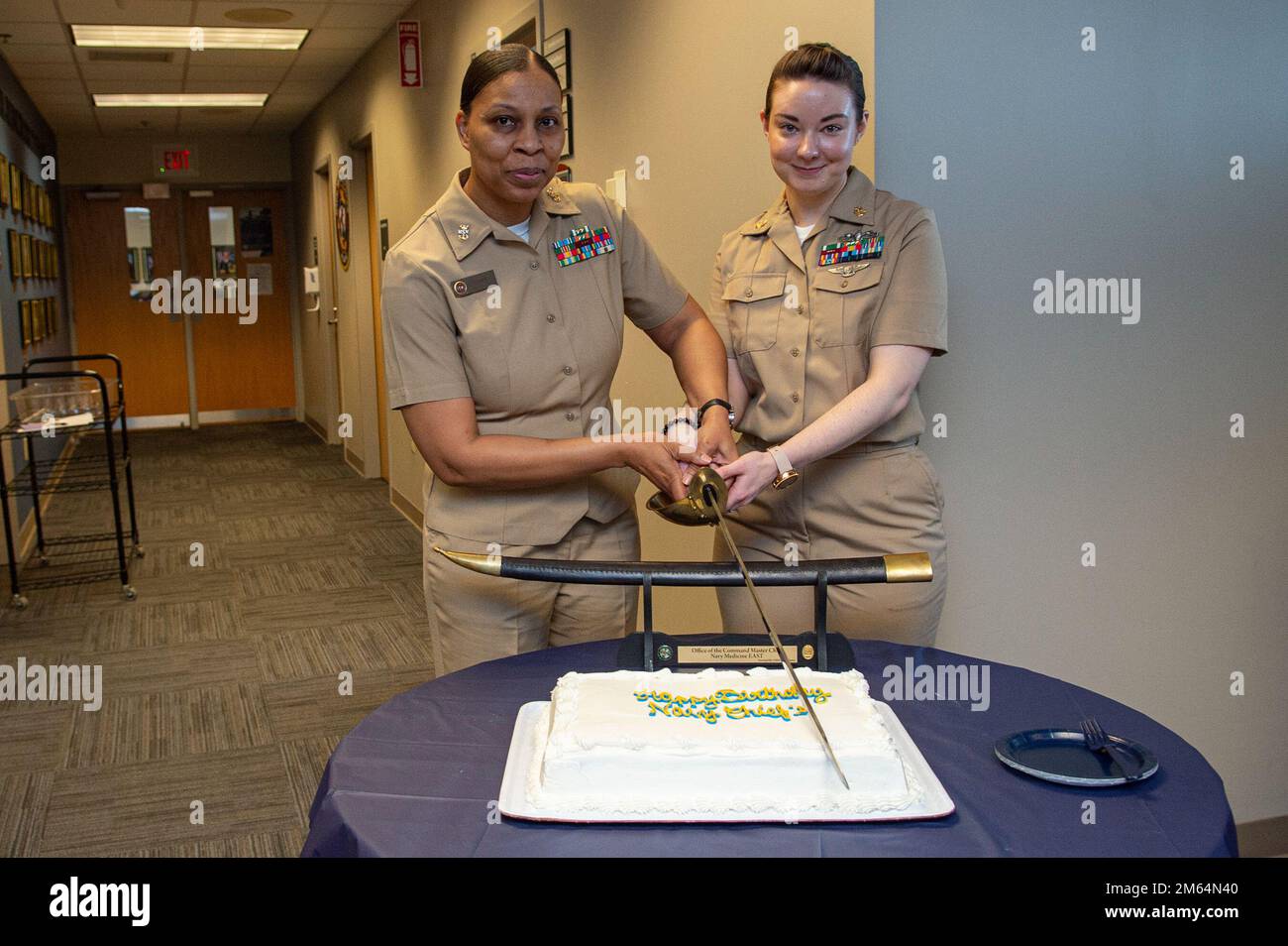 Portsmouth, Va. (Apr. 1, 2022) Master Chief Teresa Carr, left, and Chief Logistics Specialist Samantha VanWhy, assigned to Naval Medical Forces Atlantic, cut cake during the 129th Chief Petty Officer birthday celebration held on the 13th floor in Naval Medical Center Portsmouth April 1, 2022. Naval Medical Forces Atlantic, headquartered in Portsmouth, Virginia, provides well-trained medical experts, operating as high performance teams, to project medical power in support of naval superiority. Stock Photo