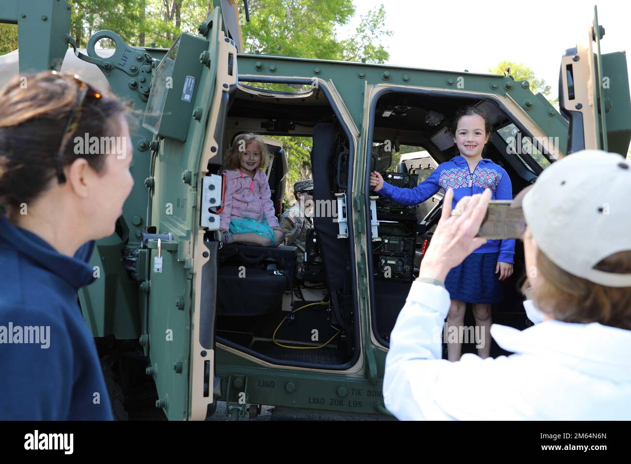 Children pose for photos inside of a 3rd Infantry Division Joint Light Tactical Vehicle at the Deer Creek Course at The Landings Club, Savannah, Georgia, April 2, 2022. The static vehicle display was a part of Military Appreciation Day, held on the second to last day of the Club Car Championship. Stock Photo