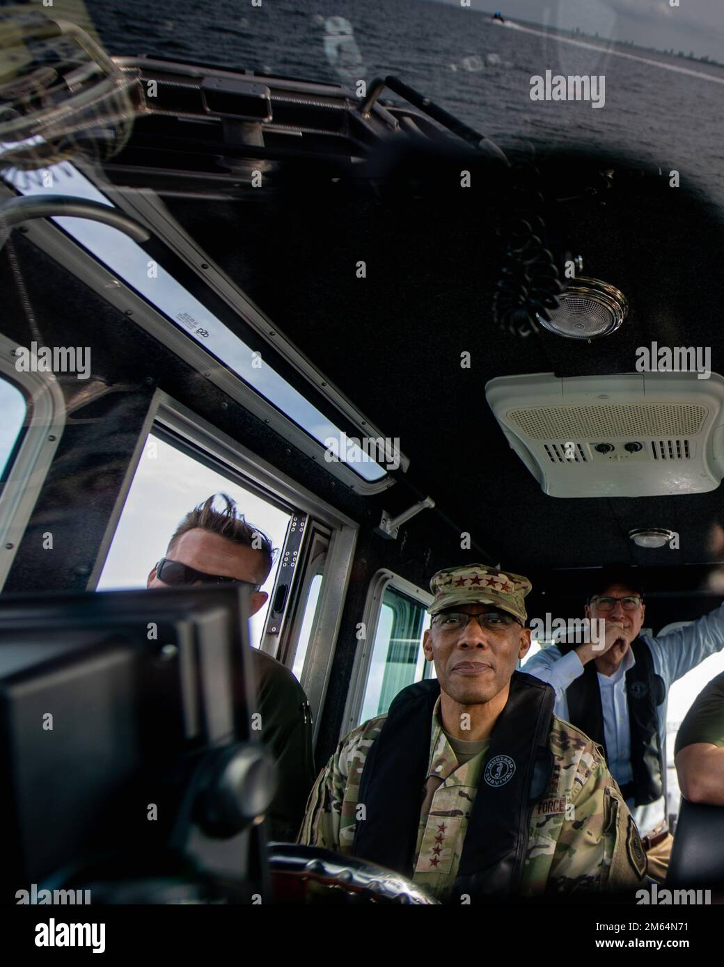 U.S. Air Force Chief of Staff Gen. CQ Brown, Jr. operates a marine patrol vessel assigned to the 6th Security Forces Squadron during a tour at MacDill Air Force Base, Florida, April 1, 2022. Gen. Brown visited the base to meet with Airmen and experience first-hand the innovative ways they're advancing the mission. Stock Photo