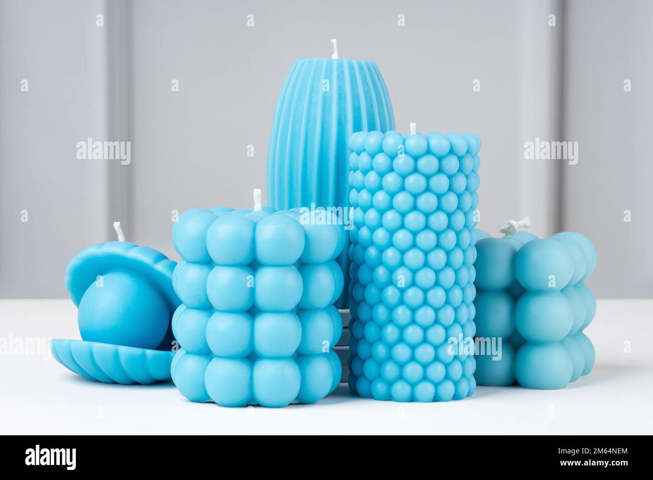 Handmade olive wax different forms blue color candle on a on the white table at home