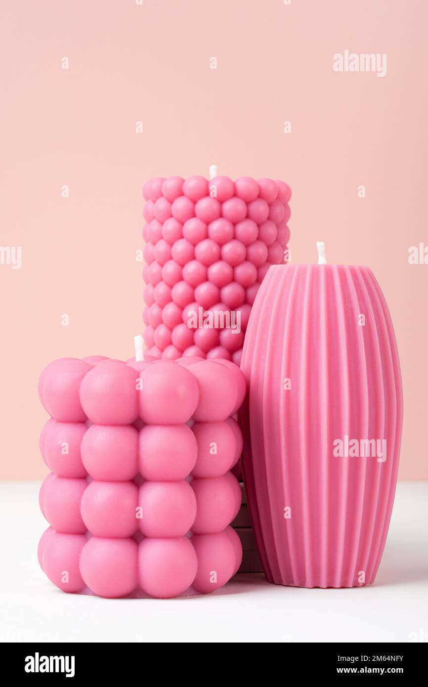 Handmade olive wax different forms pink color candle on a duotone