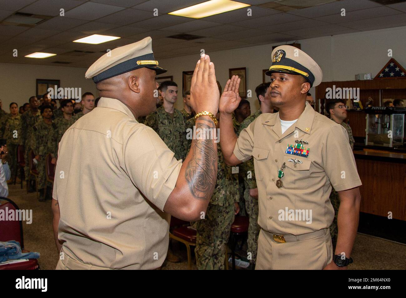 U.S. Navy Lt. j.g. Gregory Williams, left, from Birmingham, Alabama, the first lieutenant for the Wasp-class amphibious assault ship USS Iwo Jima (LHD 7), swears in U.S Navy Chief Boatswain’s Mate Lester Jones Jr., from Wilmington, Delaware, assigned to the John C. Stennis, as a chief warrant officer during his commissioning ceremony, at the American Legion Tidewater Post 327, in Norfolk, Virginia, April 1, 2022. The John C. Stennis is in Newport News Shipyard working alongside NNS, NAVSEA and contractors conducting Refueling and Complex Overhaul as part of the mission to deliver the warship b Stock Photo