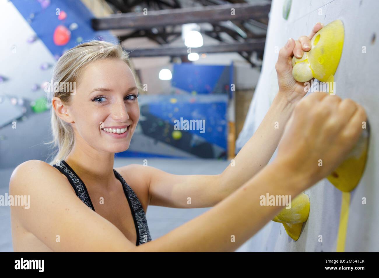 happy climber climbs a route on the climbing wall Stock Photo Alamy