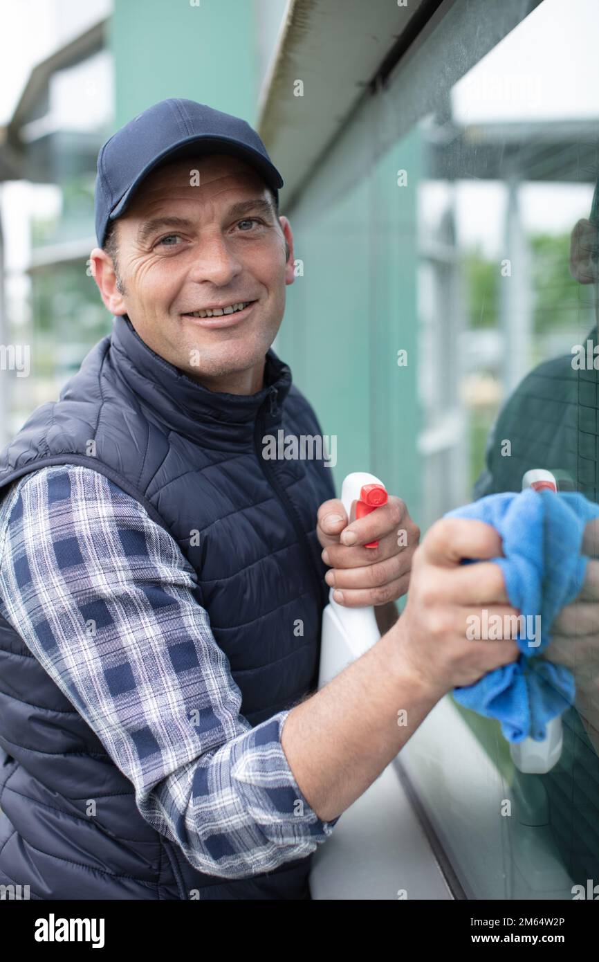 male worker washing window glass from outside Stock Photo Alamy