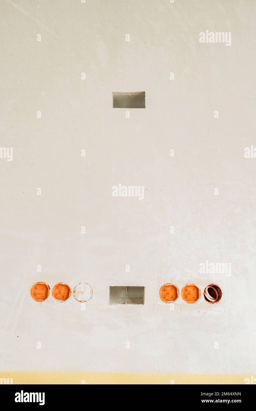 Sockets and back boxes into a wall, new construction Stock Photo Alamy