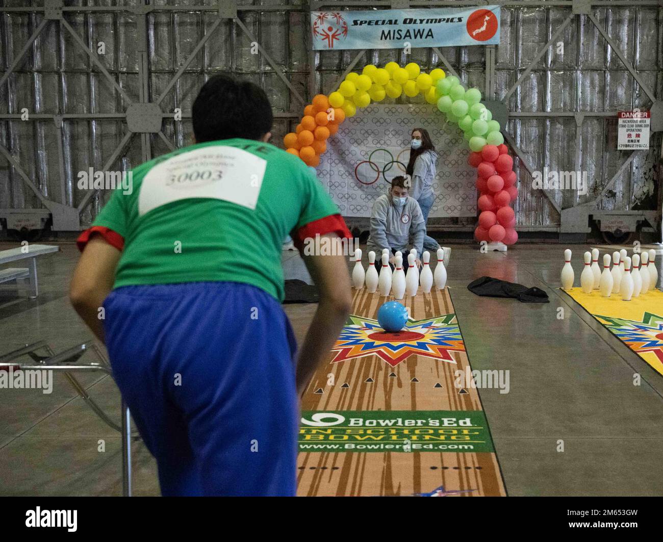 An athlete of the 2022 Misawa Special Olympics rolls a bowling ball during one of the games at Misawa Air Base, Japan, April 2, 2022. This marks the 34th year that Misawa held the Special Olympics. Stock Photo
