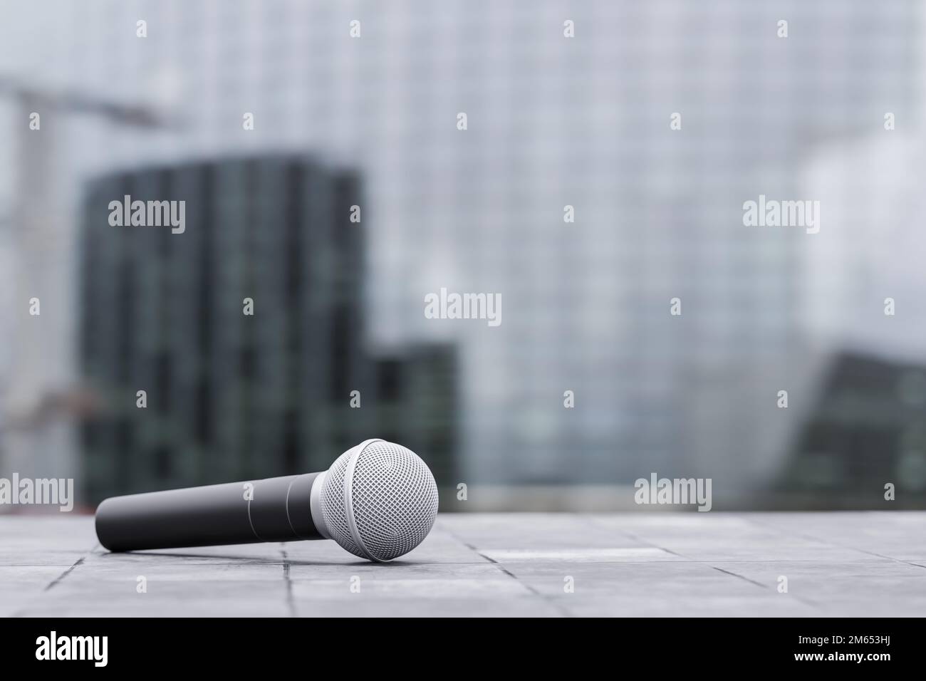 journalist microphone on city background. presentation or announcement