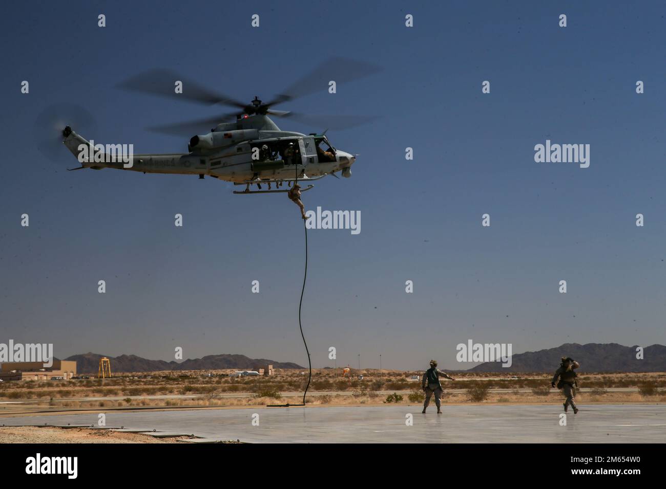 U.S. Marines with 1st Battalion, 2d Marine Regiment, 2d Marine Division (MARDIV), conduct fast-rope training during Weapons and Tactics Instructor (WTI) course 2-22 at Laguna Army Airfield, Yuma Proving Ground, Arizona, April 2, 2022. WTI is a seven-week training event, hosted by Marine Aviation Weapons and Tactics Squadron One, which emphasizes the development of small task-organized unit experimentation across all warfighting functions, as well as enhance the battalion's ability to conduct command and control, fire-support planning, intelligence functions, and logistical support to distribut Stock Photo