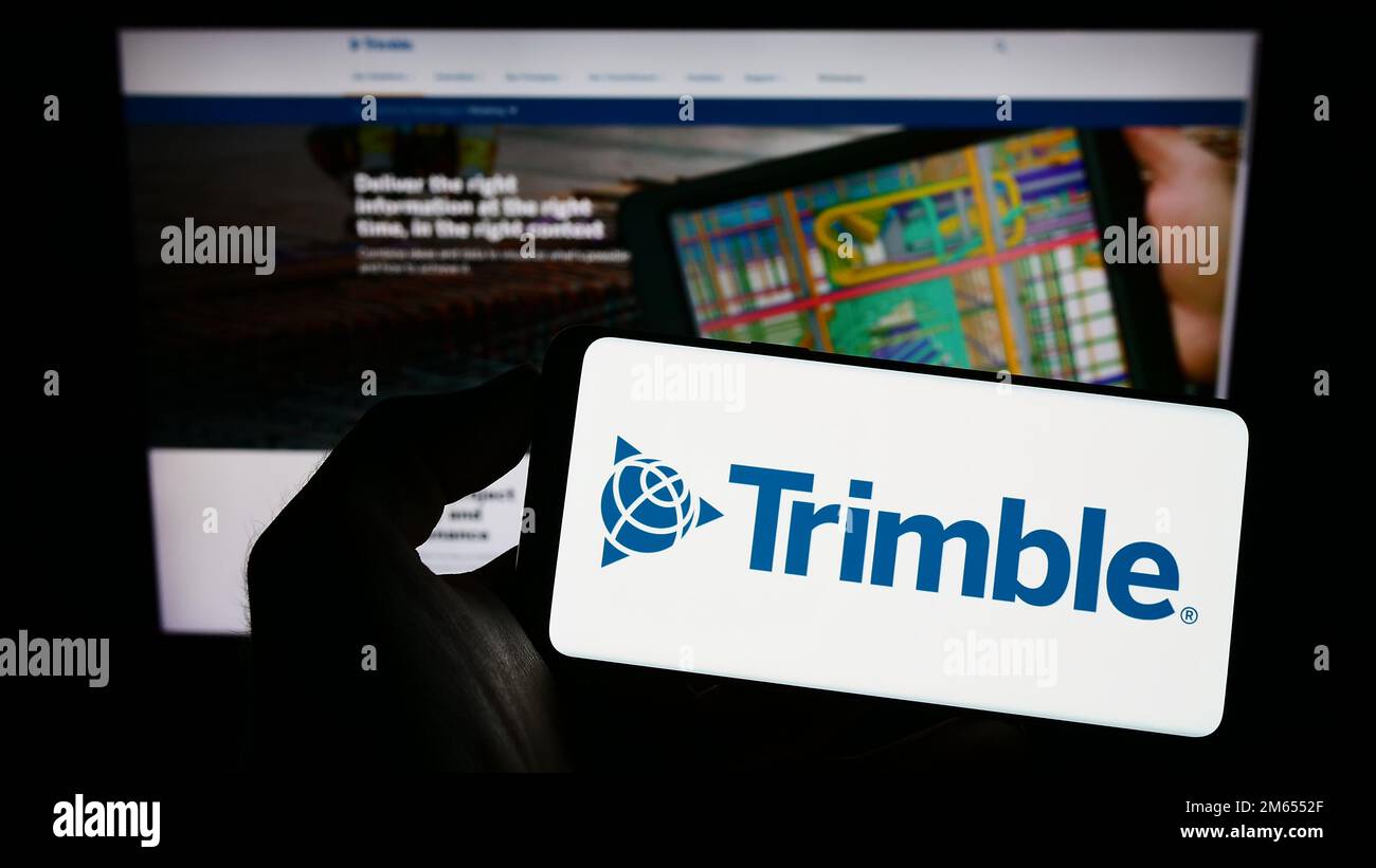 Person holding mobile phone with logo of American technology company