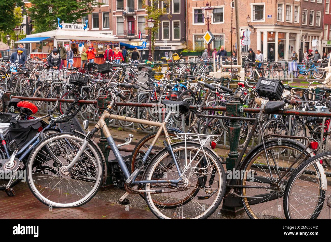 Canal bank in Amsterdam full of bicycles. Stock Photo