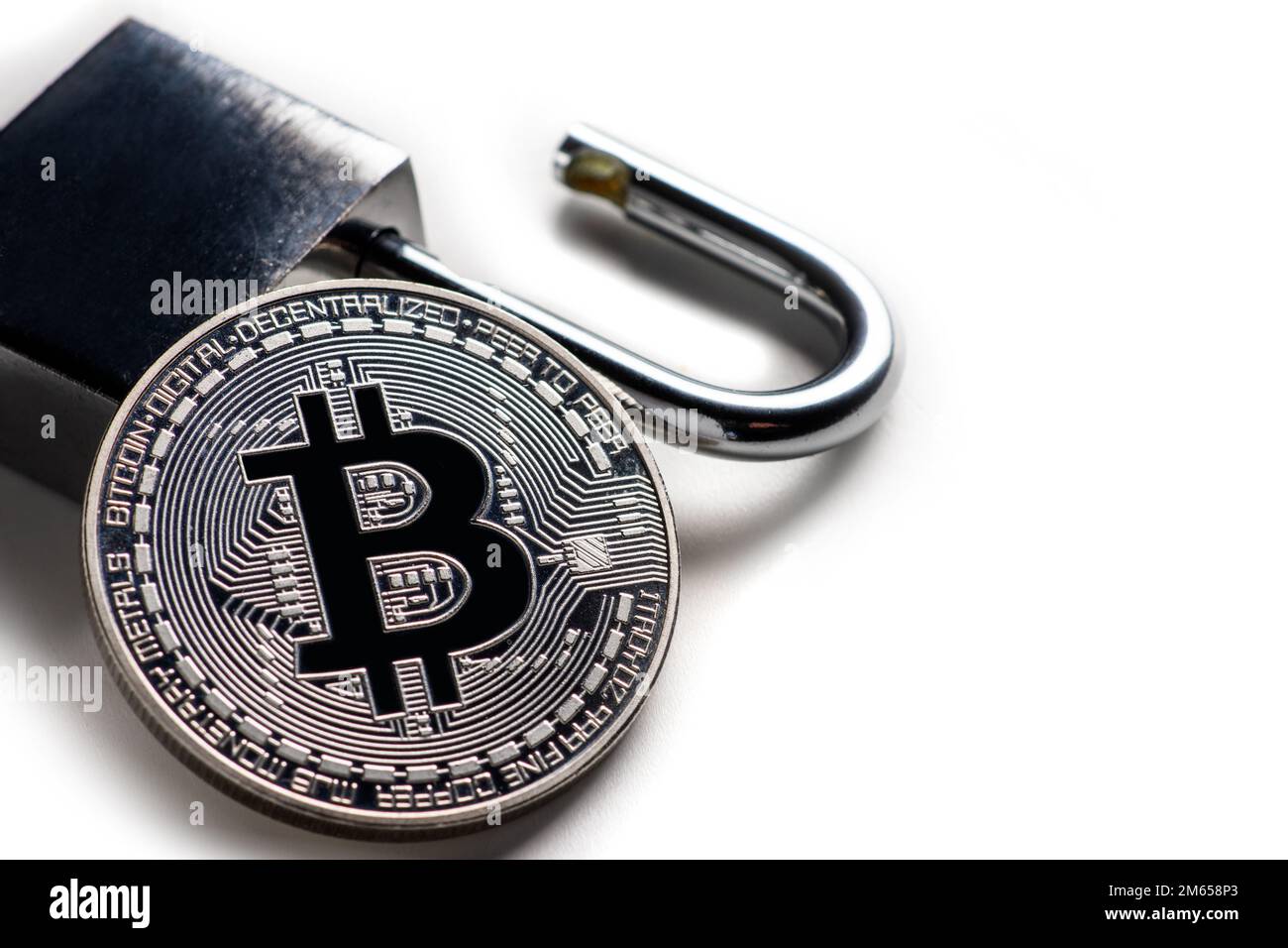 Digital currency, silver bitcoin with open padlock on white. Stock Photo