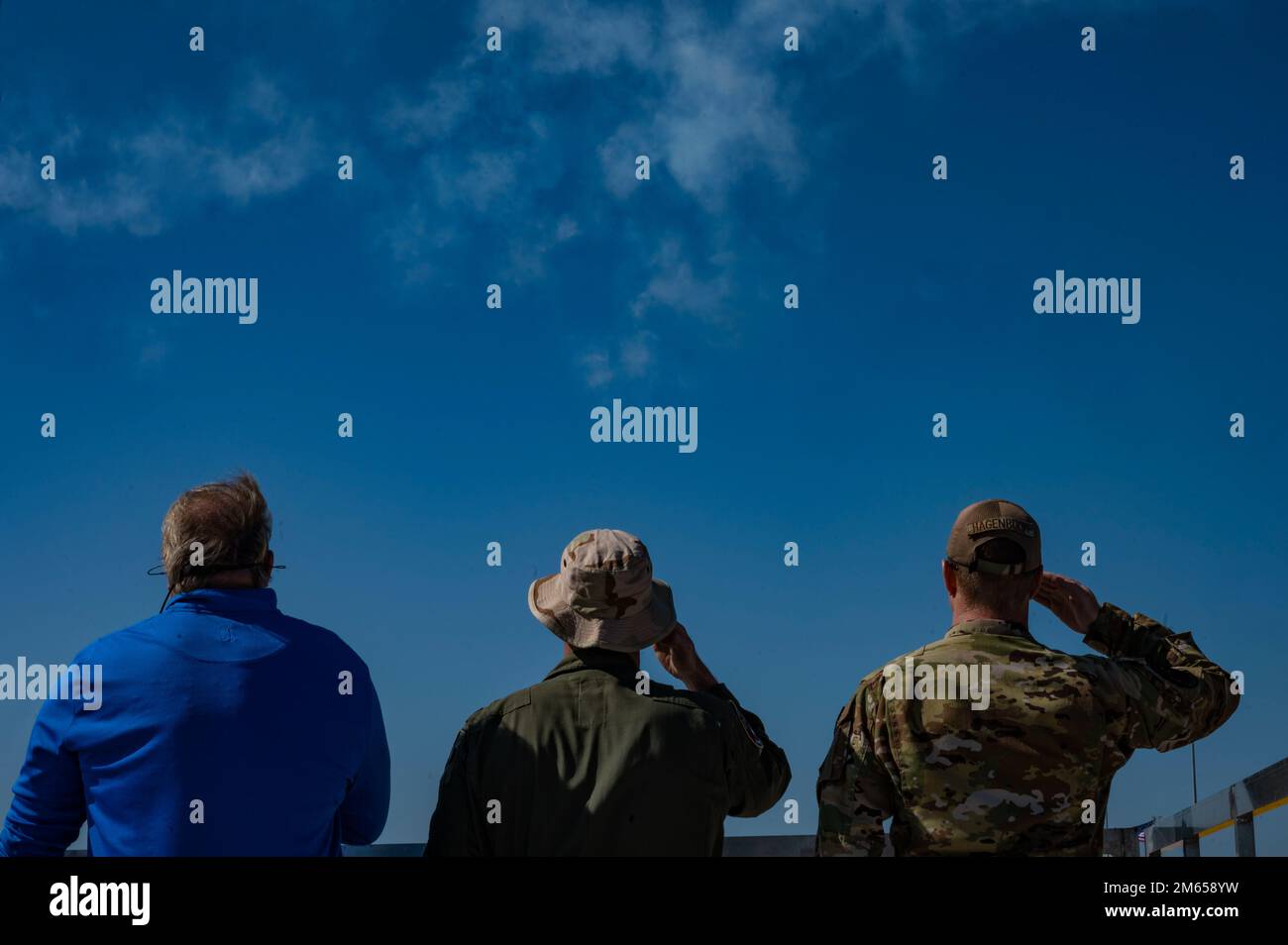 Airshow attendees salute during the National Anthem during the Shaw Air and Space Expo at Shaw Air Force Base, South Carolina, April 3, 2022. The 20th FW honored 20 individuals, nominated by their peers, for their tireless work within their communities to make them safer and improve the lives of those around them. Stock Photo