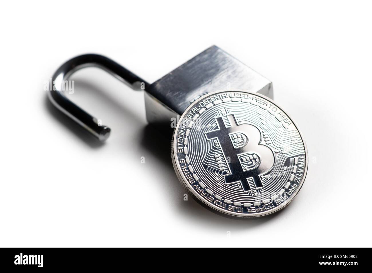 Digital currency, silver bitcoin with open padlock on white. Stock Photo