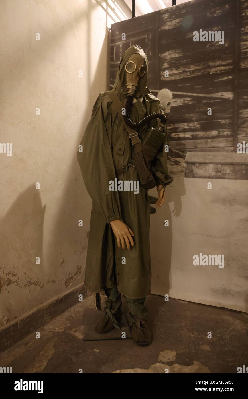 Standing figure in protective clothes including gas mask from the Cold War period, as displayed in the Nowa Huta museum in Krakow, Poland Stock Photo