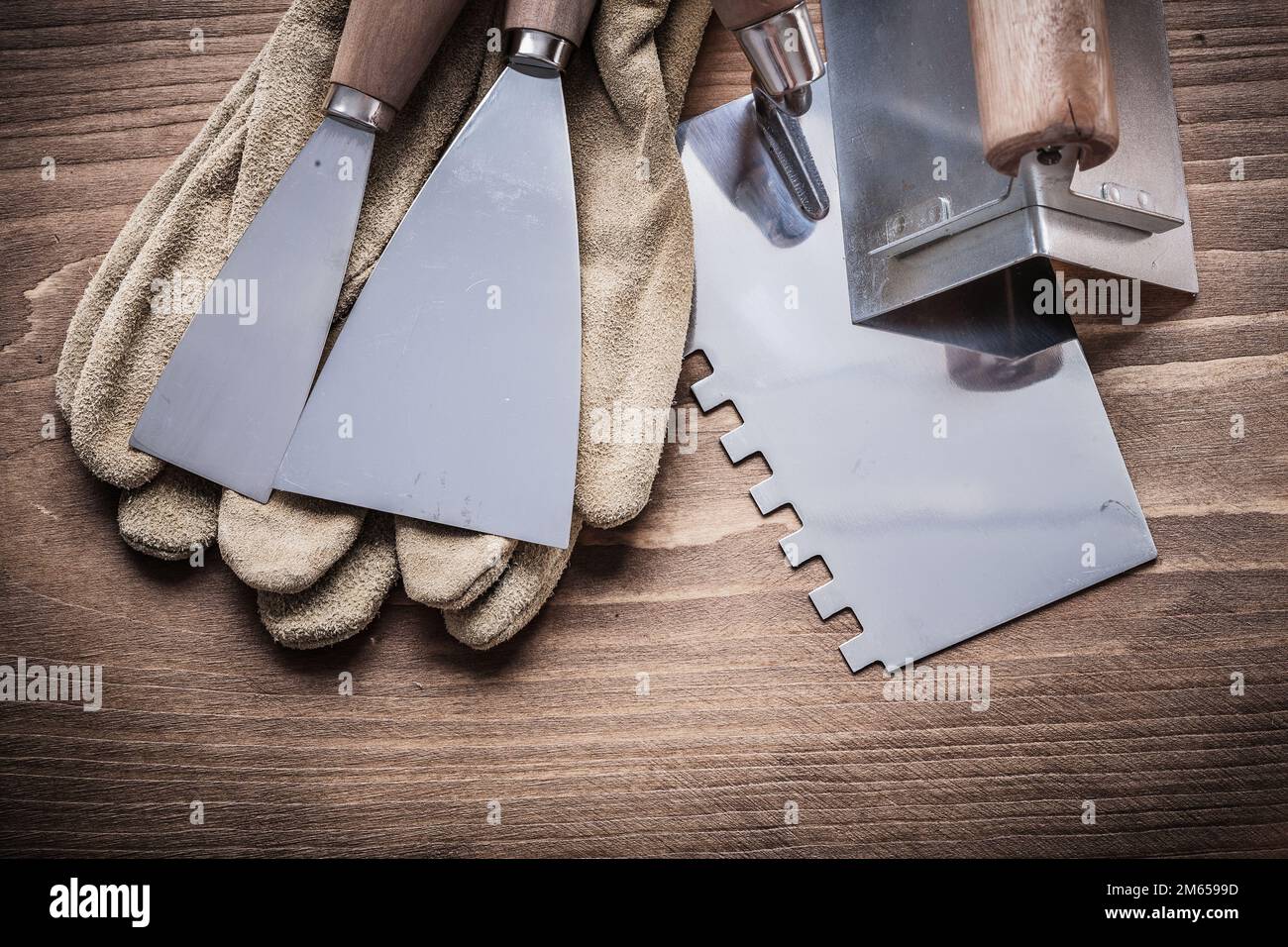 angle former two paint scrapers working gloves putty knife Stock Photo