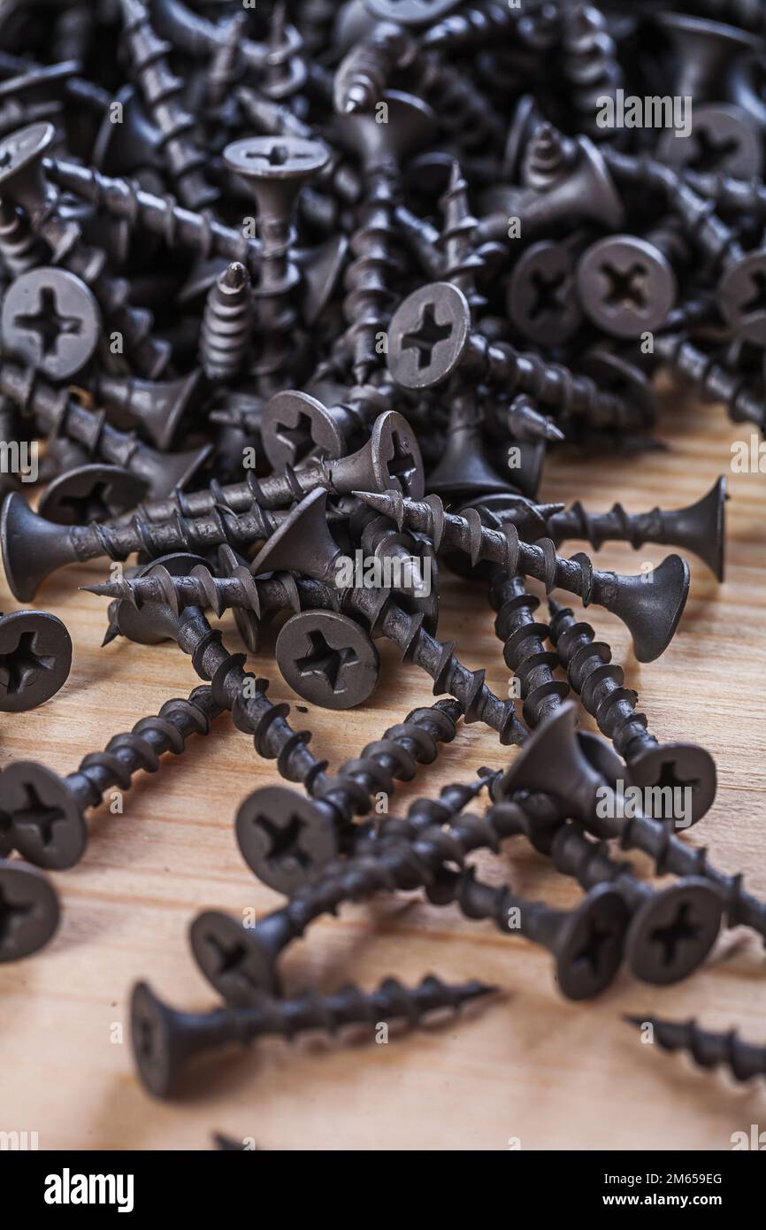 black screws for fixation of woods on wooden board Stock Photo