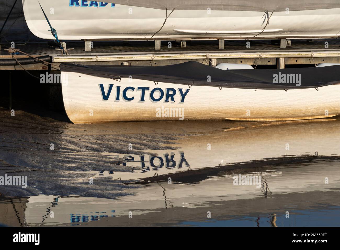 Victory. Gig, rowing boat named Victory tied up on the moorings at low tide at Hythe Quay