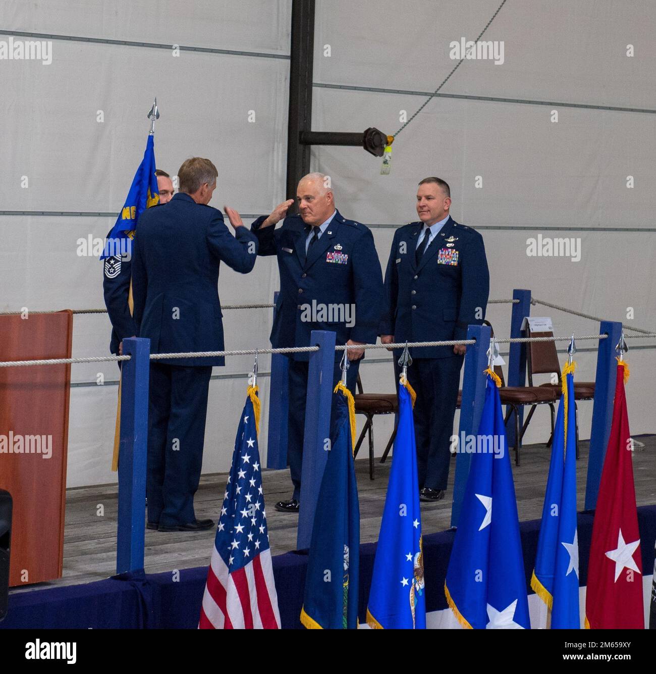 Maj. Gen. Douglas A. Farnham, Maine's Adjutant General, left, and Brig. Gen. Steven D. Michaud, middle, the outgoing commander of the Maine Air National Guard, salute while Brig. Gen. Frank W. Roy, incoming commander, stands by to begin his command during a change of command ceremony at the 101st Air Refueling Wing in Bangor on April 3, 2022. (Maine Air National Guard photo by Sr. Airman Erick Green) Stock Photo