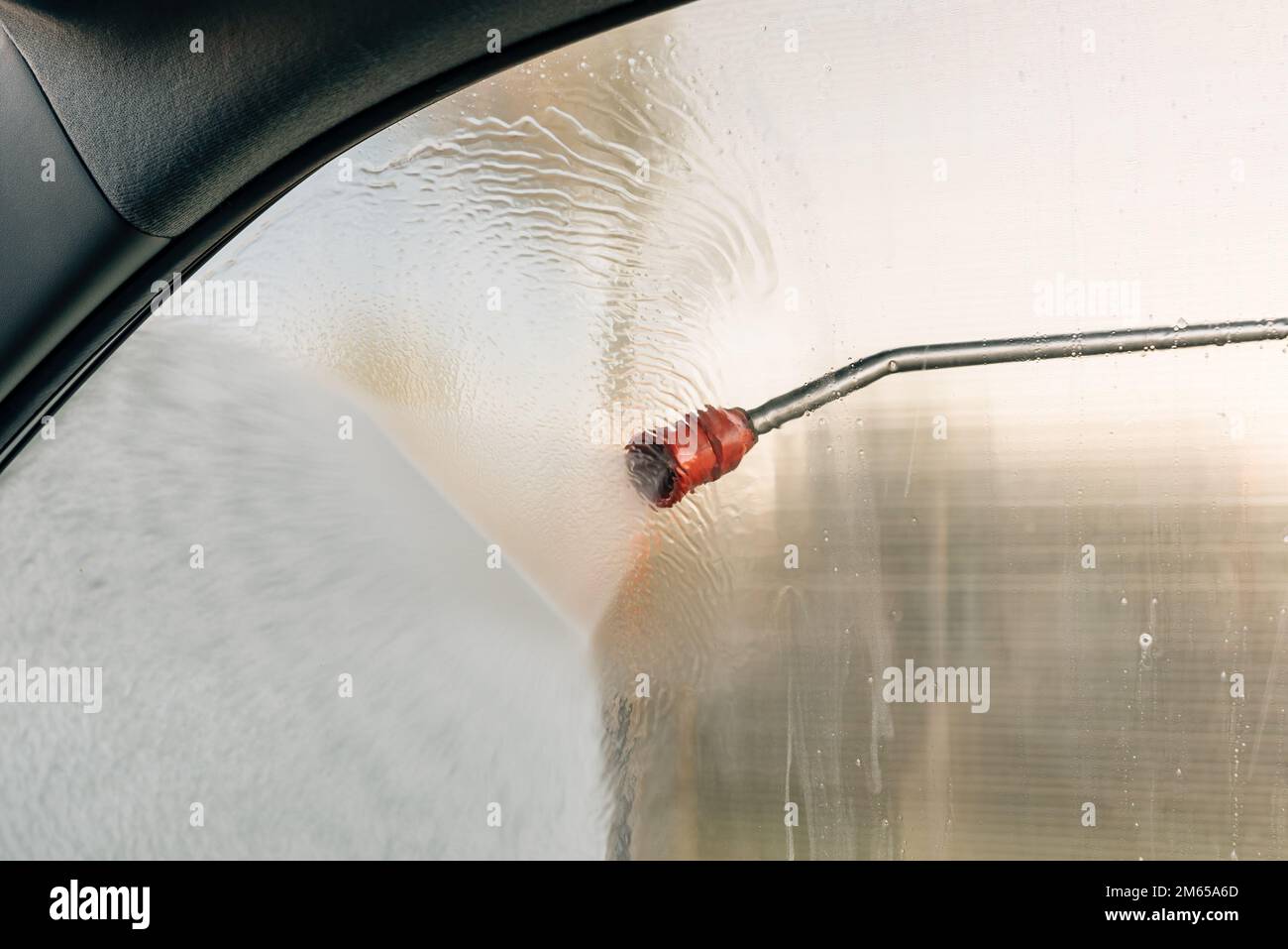 High pressure water gun jet sprayer in carwash self-service, selective focus Stock Photo