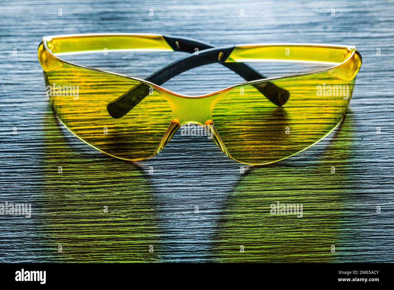 Safety goggles on wooden board top view. Stock Photo