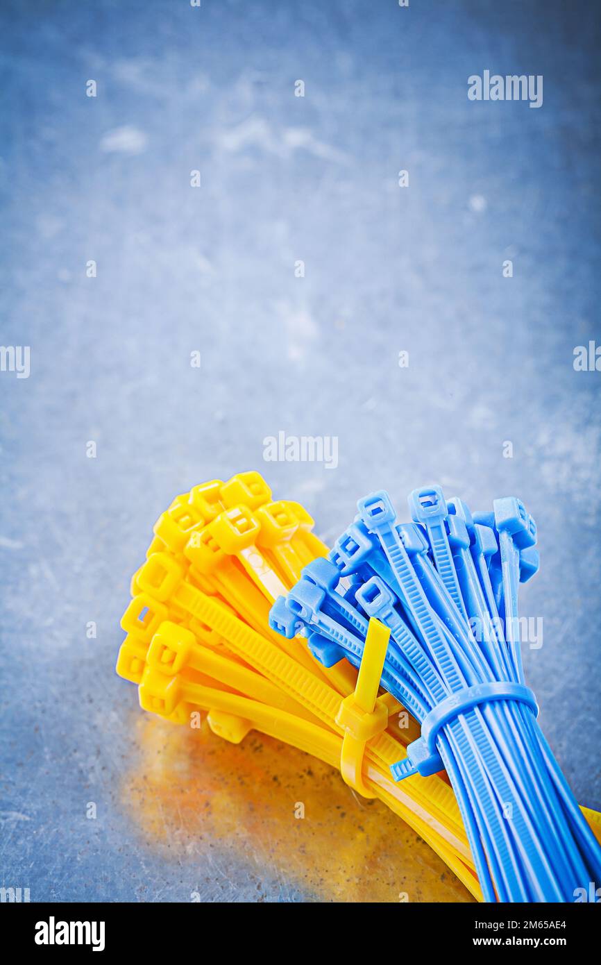 Set of self-locking cable ties on metallic background construction concept. Stock Photo