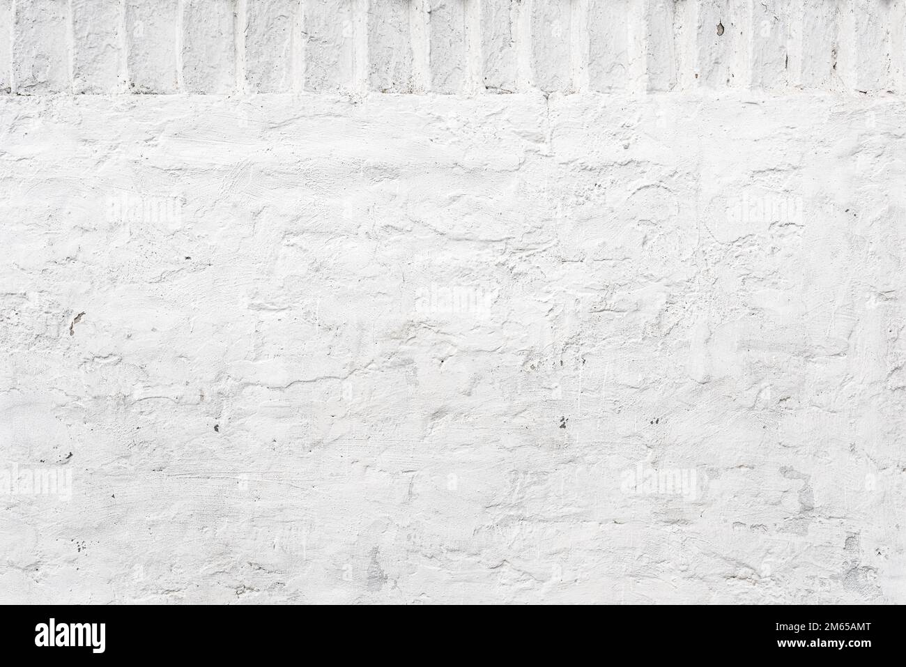 Old plaster wall painted in white with brick pattern as background
