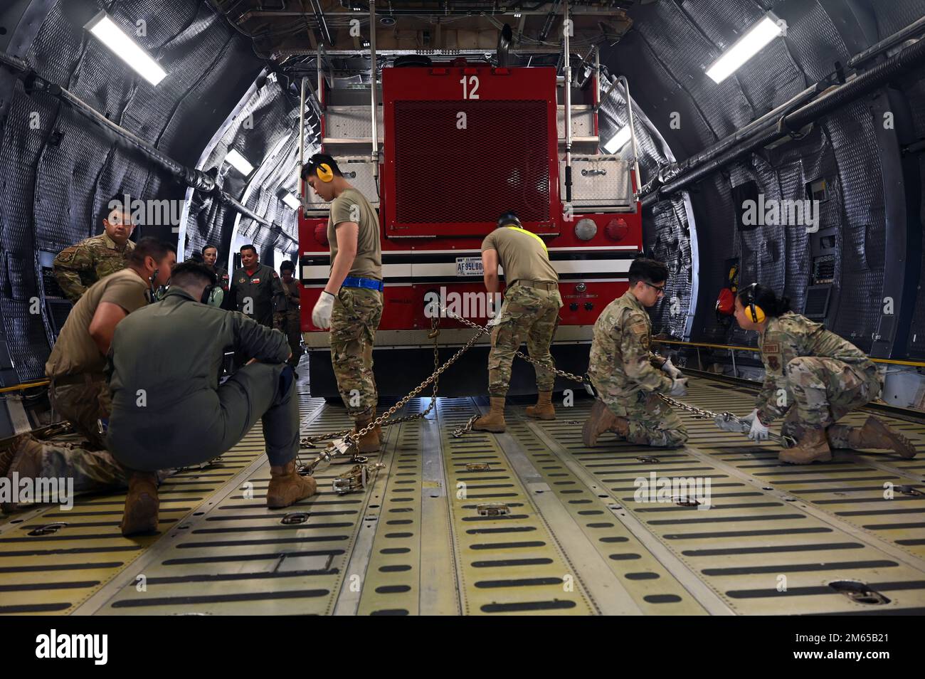 Reserve Citizen Airmen in the 74th Aerial Port Squadron work with 433rd Airlift Wing C-5M Super Galaxy aircrew to practice the on-load and offload of a firetruck April 3, 2022, Joint Base San Antonio-Lackland, Texas. Stock Photo