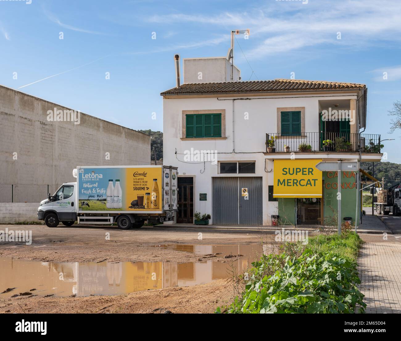 Felanitx, Spain; december 30 2022: Delivery truck of the chocolate milkshake brand Cacaolat, parked next to a small supermarket in the Mallorcan town Stock Photo