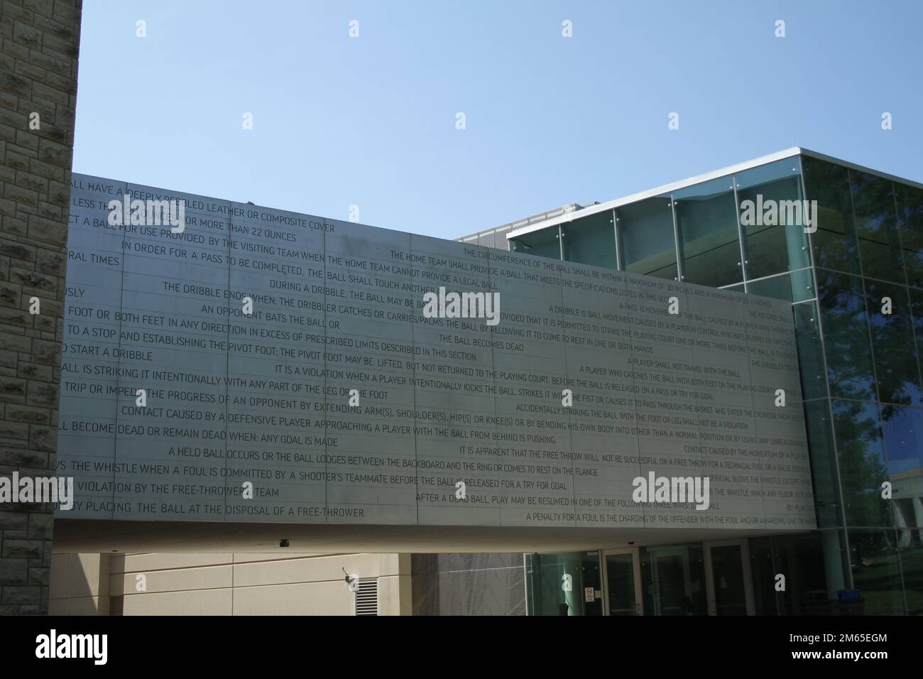 The original rules of basketball engraved on a gray overpassing walkway