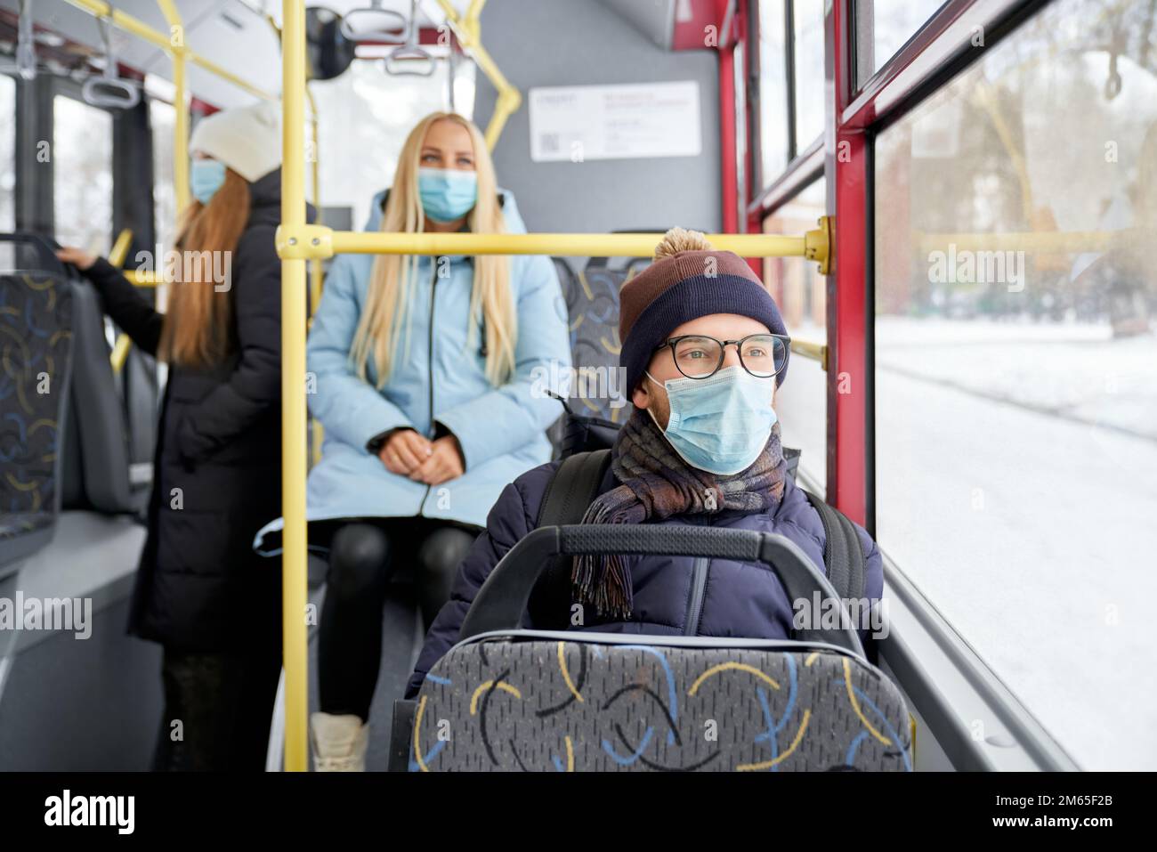 Portrait of passengers protecting themselves against coronavirus getting work home school. Ordinary day in public transport while covid spreading. Con Stock Photo
