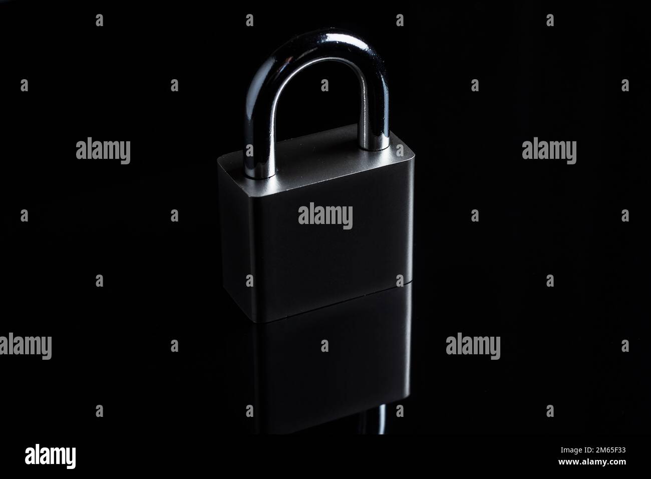 Steel padlock on the black textured background Stock Photo - Alamy