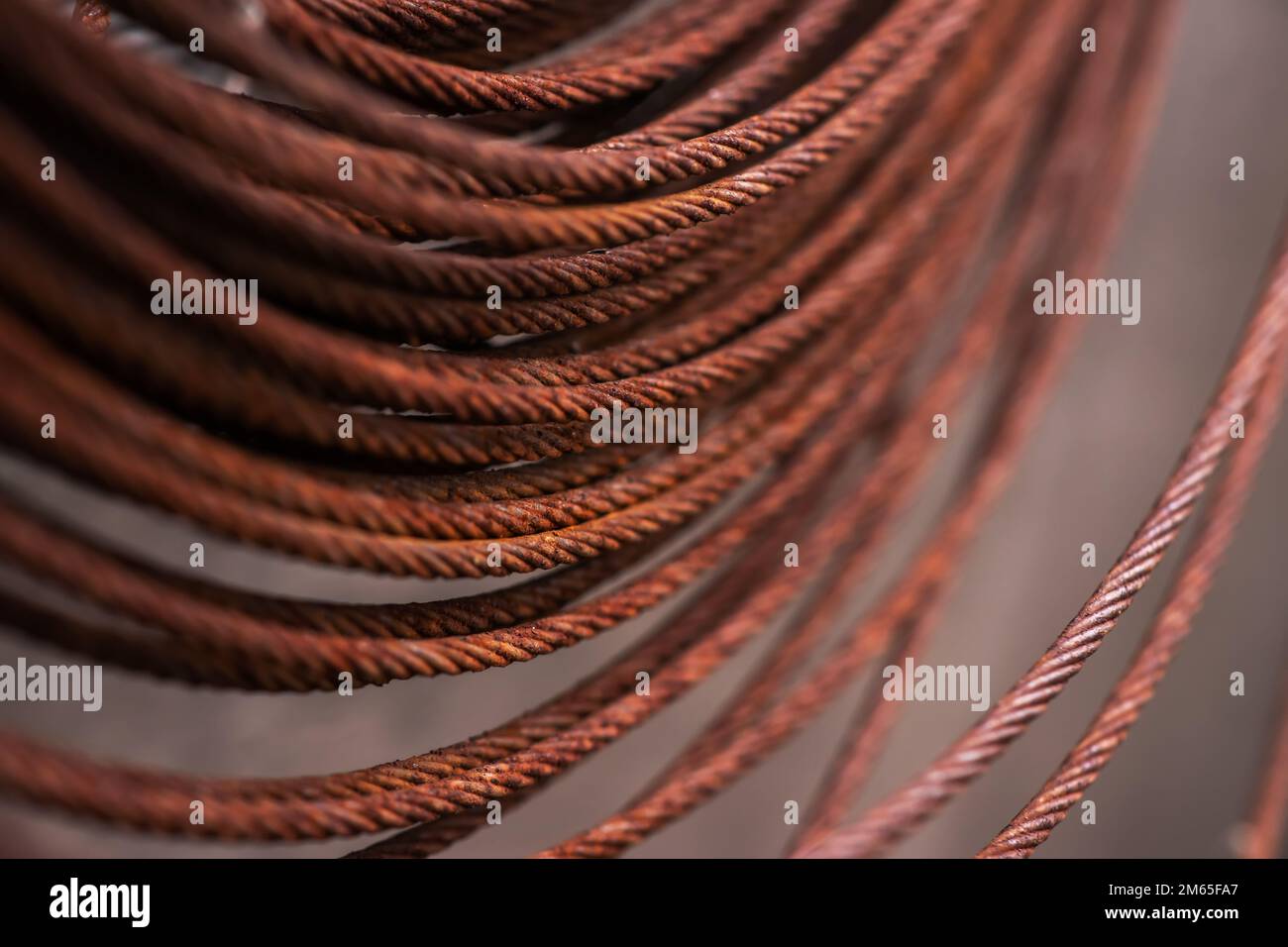 Round rusty steel wire coils. Metal reels for further industrial processing Stock Photo