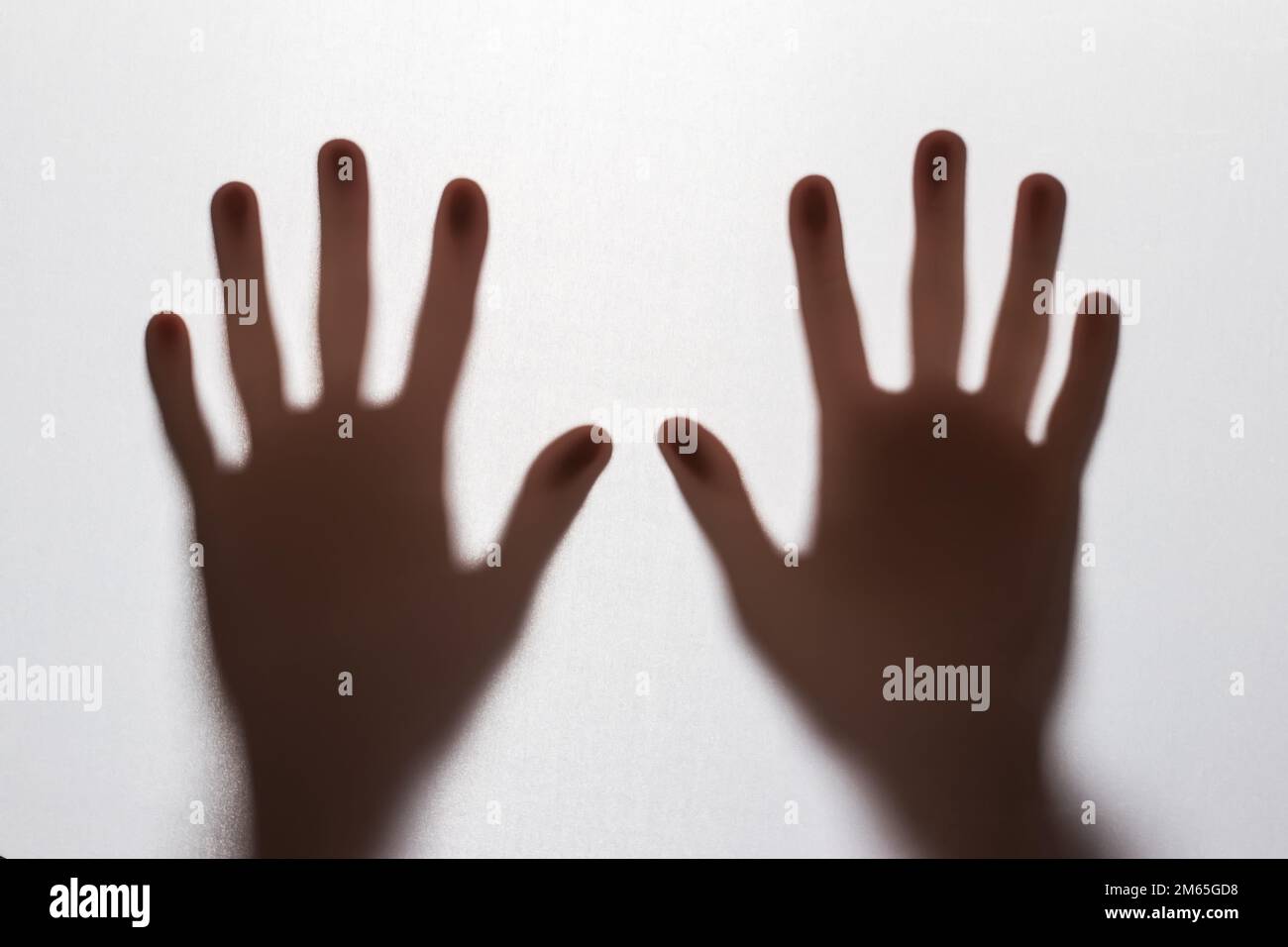 Abstract blur hands silhouettes behind glass foreground Stock Photo Alamy