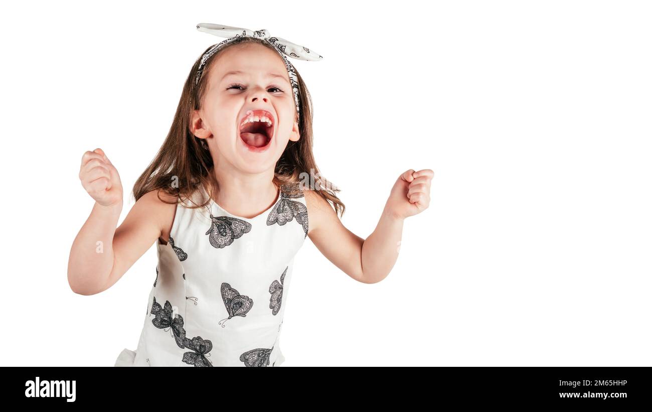 Crazy little girl loudly scream clenching fists. Portrait of child isolated on white. Emotional facial expression, splash out feelings. Saint Valentin Stock Photo