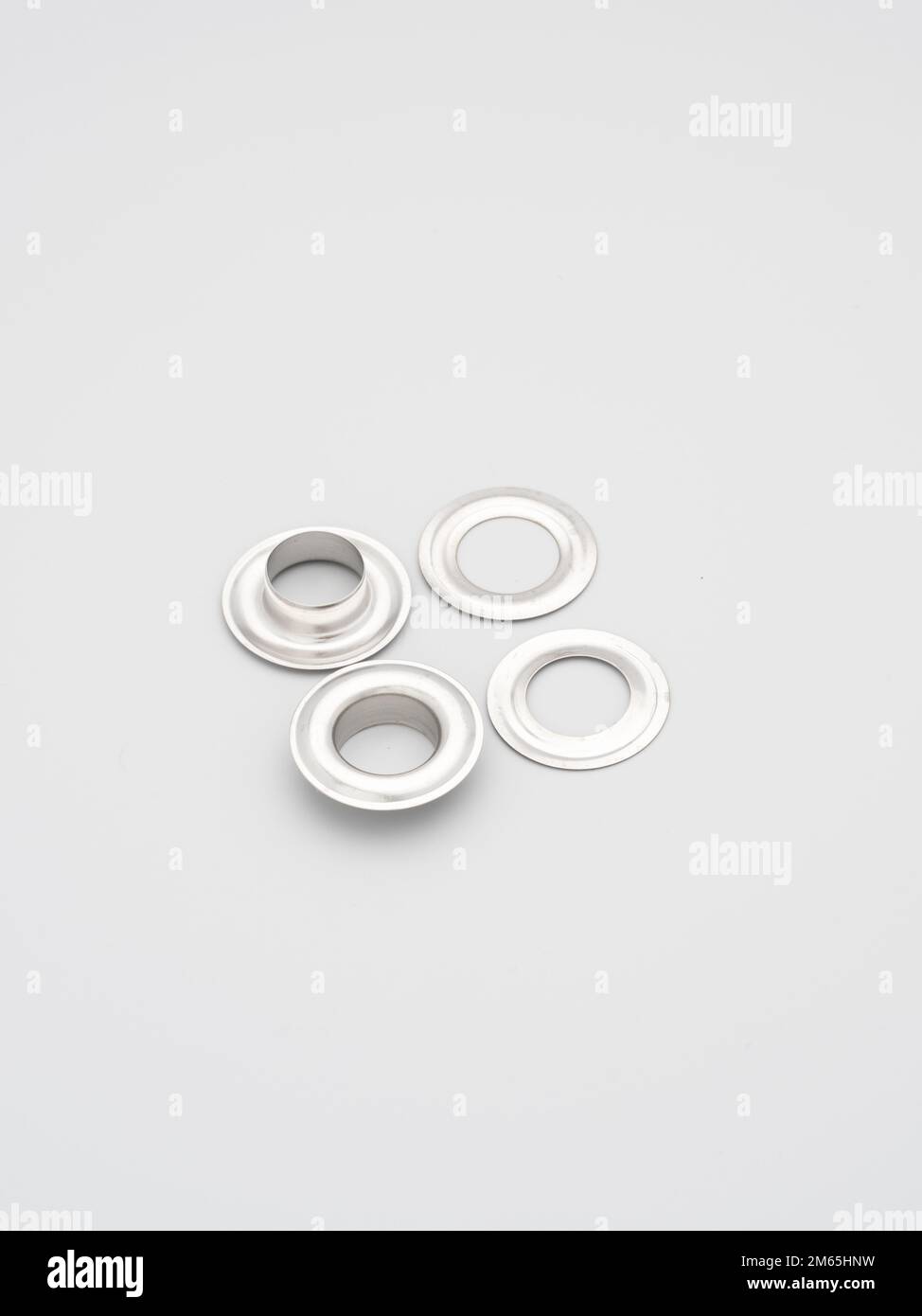 Metal accessories and supplies for bags, backpacks and sewing laying on a grey background. Chrome-plated metal frames for handbags straps. Sewing, bag Stock Photo