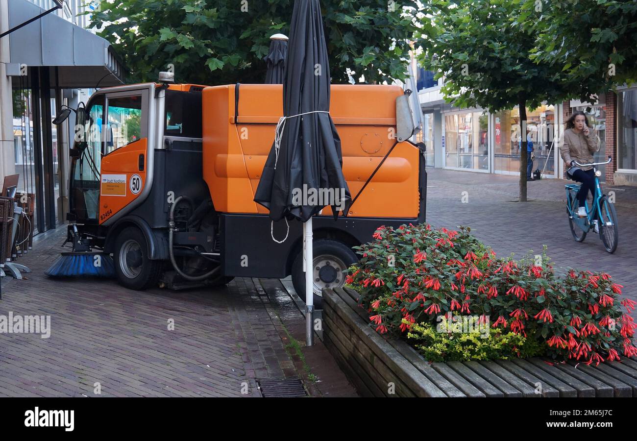 Nordhorn, Germany Aug 19 2016 Before the shops open, the shopping street is cleaned with. A road sweeper drives around obstacles. Stock Photo