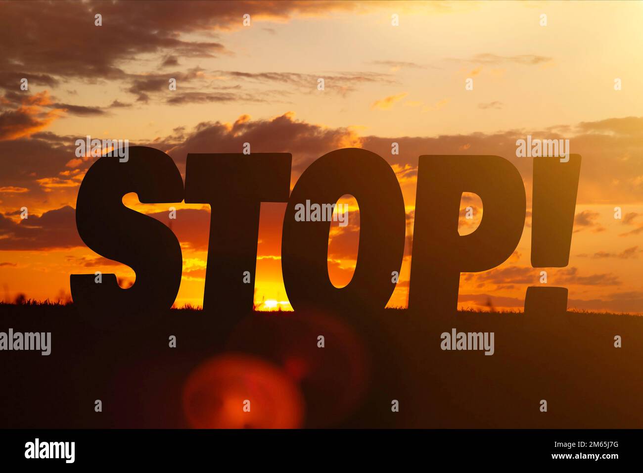 The inscription stop against the background of a bright sunset. Closing and care concept.. Stock Photo