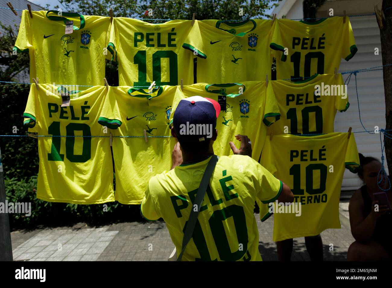 Santos, Brazil. 02nd Jan, 2022. A man sells jerseys with Pelé's name and the number 10, which