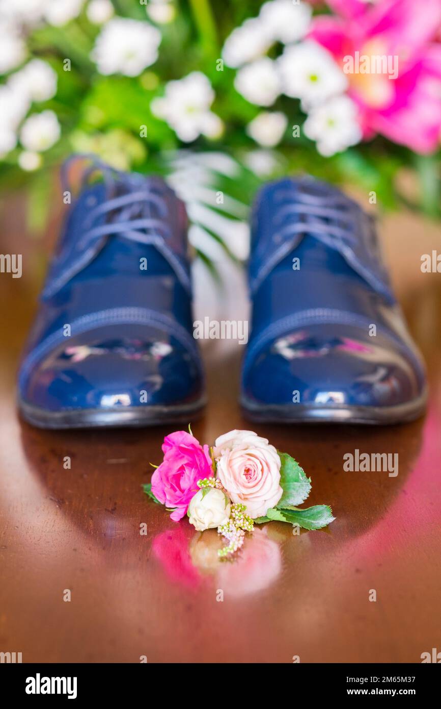 Small bouquet with flowers laying near man wedding clothes. Stock Photo