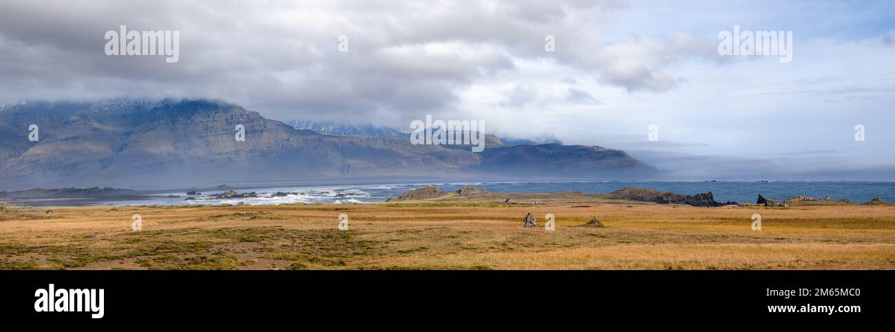 View during auto trip in Iceland. Spectacular Icelandic landscape with  scenic nature: mountains, ocean coast, fjords, fields, clouds, glaciers, water Stock Photo