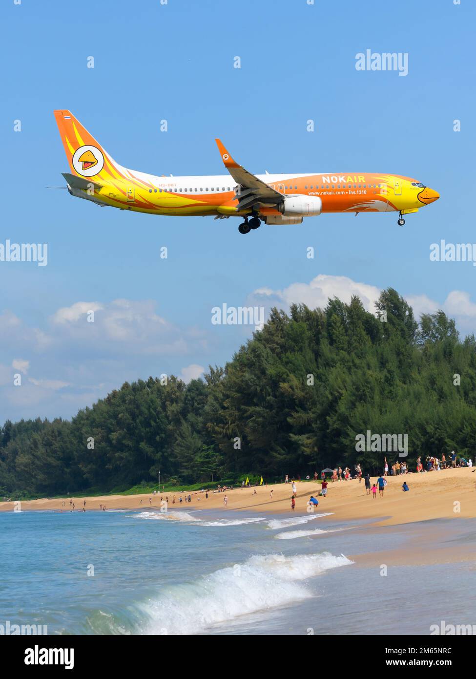 Nok Air Boeing 737 aircraft flying over Mai Khao Beach before landing at Phuket Airport. Airplane 737-800 of NokAir Thailand (Nok Air Thailand). Stock Photo