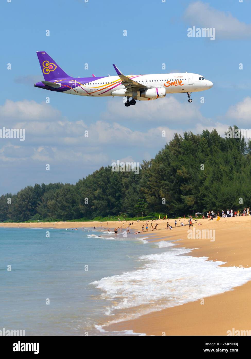 Thai Smile airline Airbus A320 aircraft over Mai Khao Beach. Airplane A320 of Thai Smile Airways. Plane hs-txo. Stock Photo