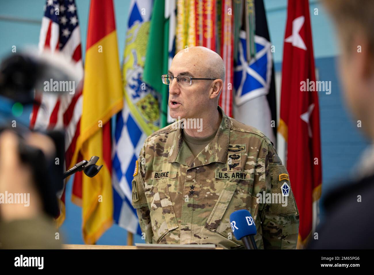 ANSBACH, Germany - Maj. Gen. Robert Burke, deputy commanding general of support, V Corps, addresses the press during a press conference in Ansbach after a welcome ceremony at Barton Barracks in Ansbach, Germany, Tuesday, April 5. During the ceremony, the V Corps headquarters and the headquarters and headquarters battalion uncased their colors at their temporary home. The presence of the entire Victory Corps headquarters in Europe expands U.S. Army Europe and Africa’s ability to command land forces in Europe and sends a strong message to our NATO allies and partners that the United States is co Stock Photo
